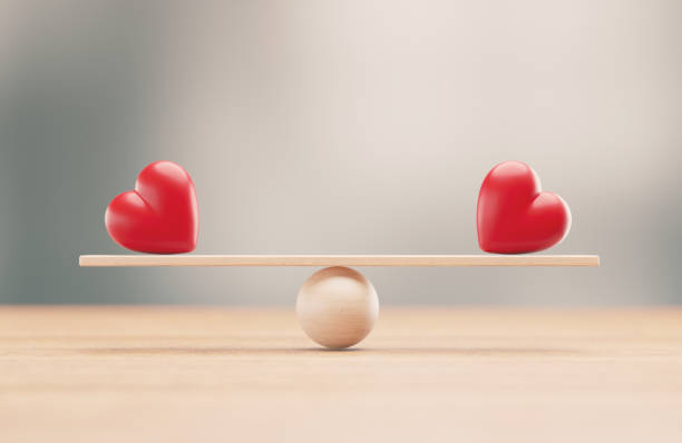 istock Red Hearts On A Wood Balance Scale - Love Concept 2201853419