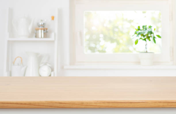 istock Wooden table top on blurred room shelf and window sill interior background with copy space 2201853512