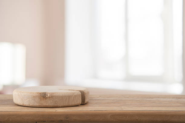 istock Empty podium on wooden table with blur room and window interior background for design mock-up placement 2201853524