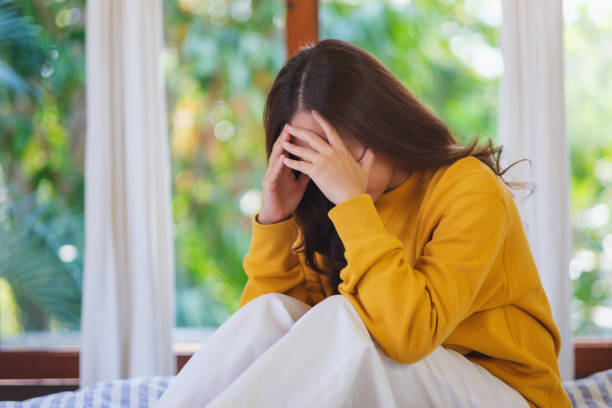 istock A woman get sick and headache at home 2201853693