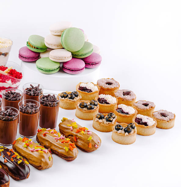 istock Delightful dessert spread featuring layered treats, pastries, and colorful macarons at a festive gathering 2201854297