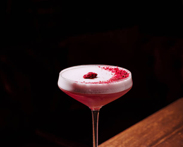 istock Sipping a vibrant raspberry cocktail in an ambient bar setting at night 2201854931