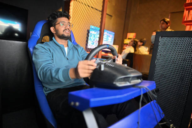 istock Young man focused on car racing game in a gaming hub 2201856845