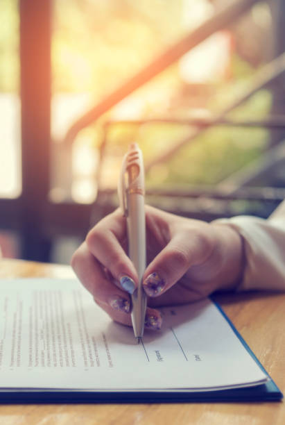 istock Vertical Horizon Woman hands writing empty notebook planing meeting agenda on wooden table. Vertical Close up women hands using pen planning. Female hand holding pen note Personal Organizer diary 2201856875
