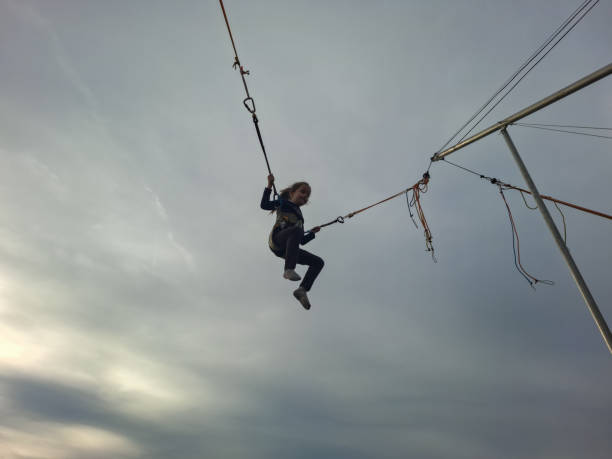 istock Girl is jumping on a bungee trampoline 2201857034