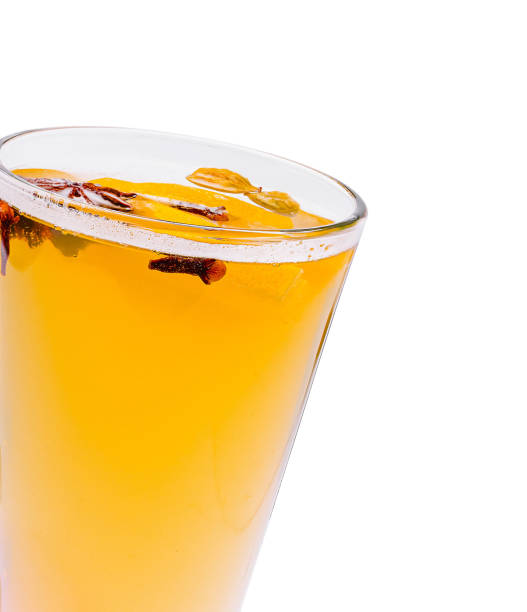istock Warm spiced drink with cinnamon and cloves served in a clear glass cup on a white background at a cozy café 2201857113