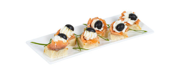 istock Assorted tapas with fish, black olive and creme cheese on white plate 2201857209