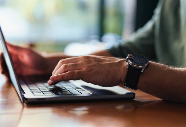 istock Person Typing on a Laptop Wearing a Watch in a Professional Setting 2201858170