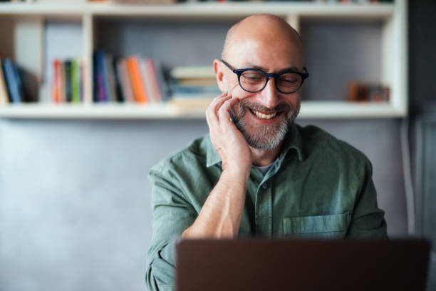 istock Smiling Professional Working on Laptop in Bright Cozy Office Environment 2201858184