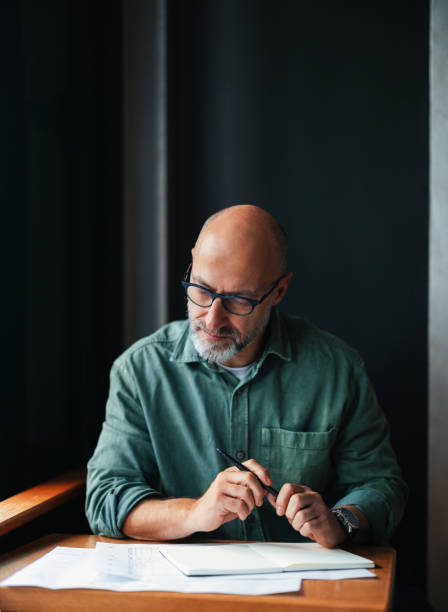 istock Businessman Working Thoughtfully at Desk in an Office Setting 2201858221