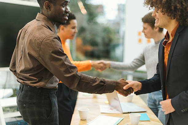 istock Diverse professionals shaking hands in office meeting 2201859558