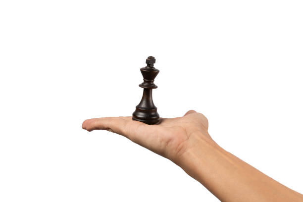istock Male hand offering a a black king chess figure isolated on white background 2201860278