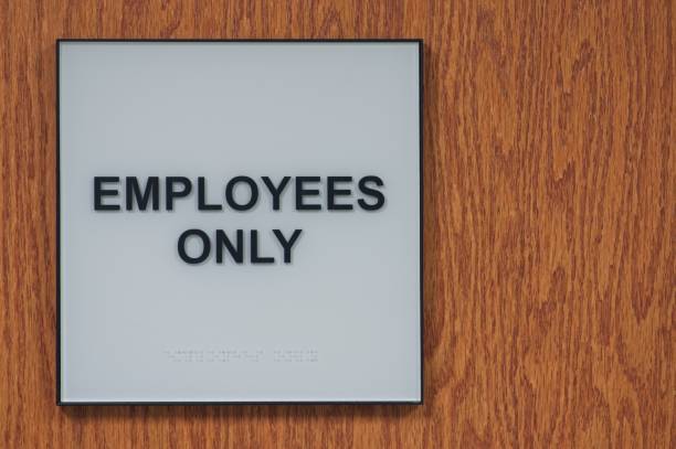 istock Sign that reads Employees Only on a wood background 2201861199