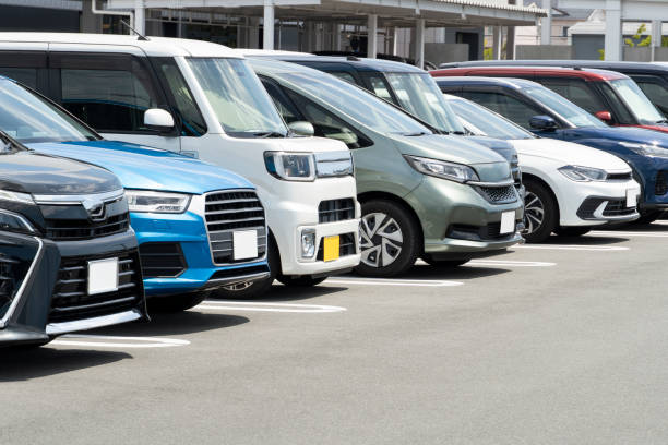 istock Cars lined up in a parking lot 2201862537