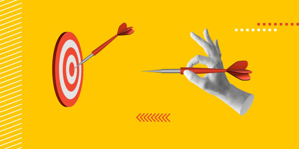 istock Focus and success, precision and goal-setting concept. Hand holding a red dart aimed at a bullseye. Minimalist art collage 2201863965