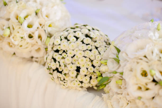 Wedding decor. Bouquets of white flowers on the wedding table in restaurant.