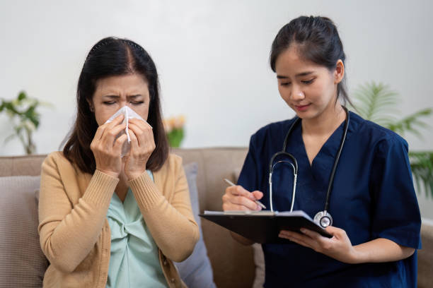 istock Elderly patient experiencing discomfort, caregiver providing support and taking notes. 2201864518
