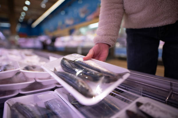 Customers choosing fish at a supermarket