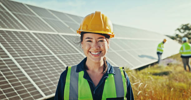 istock Woman, portrait and solar engineer at farm, energy saving and supervisor for panel maintenance. Female person, renewable power supply and outdoor for ecology project, safety helmet and grid field 2201865130