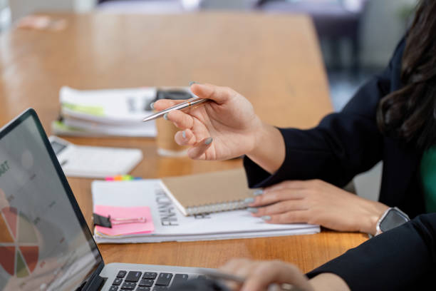 istock Financial team analyzing data and planning strategies during a meeting. 2201865642