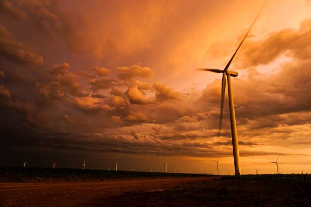 istock Dramatic sunset sky over a wind farm with turbines silhouetted against vibrant clouds 2201867296