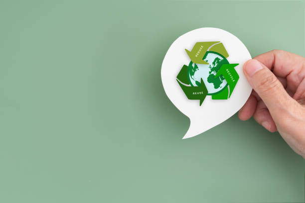 istock For recycle volunteer, campaign, reduce, reuse, recycle, net zero concept. Hand hold real white speech bubble paper cut with green recycle symbol and earth icon, copy space included 2201867674