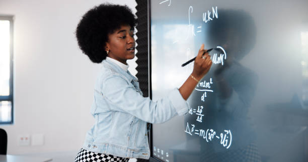 istock Education, black woman and student by board in classroom explaining science equation at college. Revision, lecture and female person with physics research for university exam, test or assignment. 2201869888