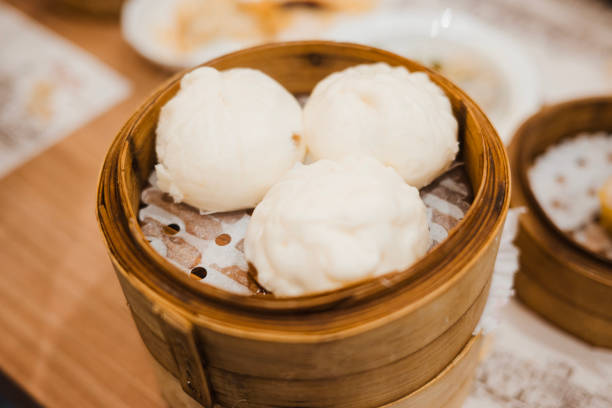 Steamed char siew bao marinated pork meat Chinese bun bao white round bun in bamboo basket asian Hong Kong dim sum