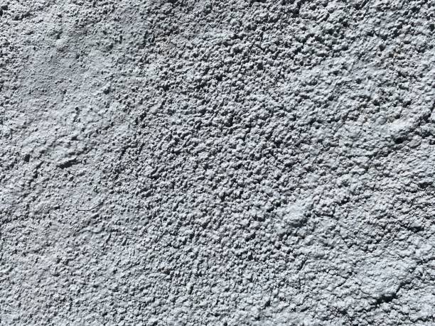istock Dusty concrete texture featuring a rugged cement surface with natural imperfections and subtle cracks. The aged, dusty finish offers an industrial vibe, perfect for minimalist designs. Floor texture. Wall background 2201872091