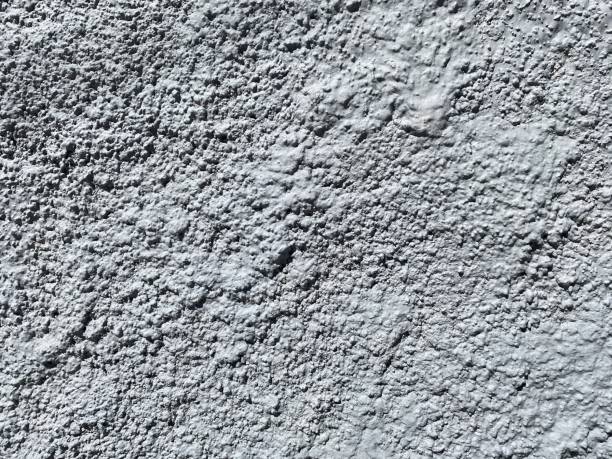 istock Dusty concrete texture featuring a rugged cement surface with natural imperfections and subtle cracks. The aged, dusty finish offers an industrial vibe, perfect for minimalist designs. Floor texture. Wall background 2201872112