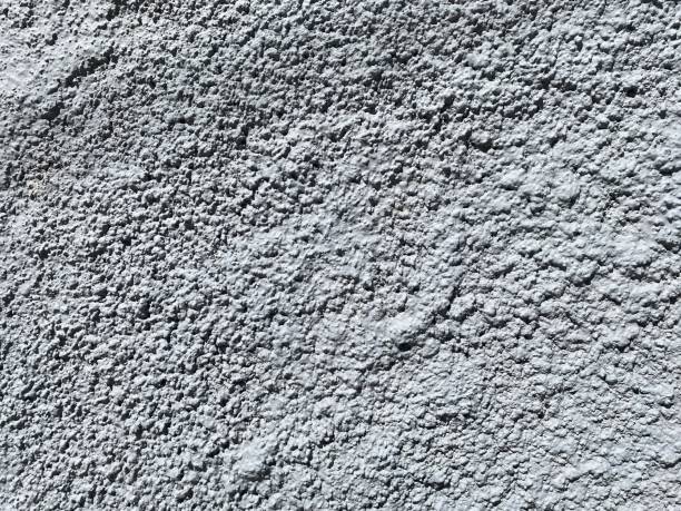 istock Dusty concrete texture featuring a rugged cement surface with natural imperfections and subtle cracks. The aged, dusty finish offers an industrial vibe, perfect for minimalist designs. Floor texture. Wall background 2201872127