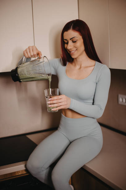 istock Sports woman drinking smoothie after practice 2201873491