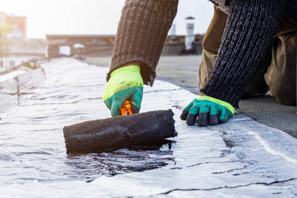 istock a young worker treats a roof with bitumen primer before applying rolled asphalt roofing using a torch 2201873495