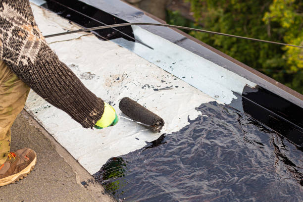 istock a young worker treats a roof with bitumen primer before applying rolled asphalt roofing using a torch 2201873502