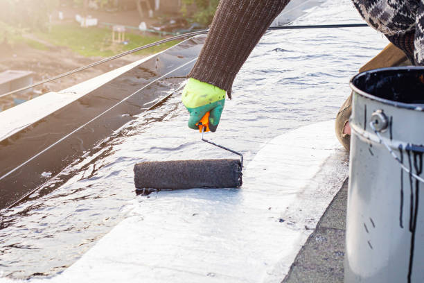 istock a young worker treats a roof with bitumen primer before applying rolled asphalt roofing using a torch 2201873509
