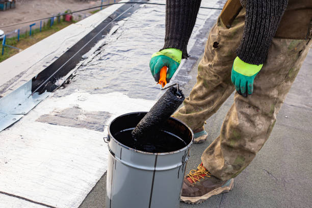 istock a young worker treats a roof with bitumen primer before applying rolled asphalt roofing using a torch 2201873514