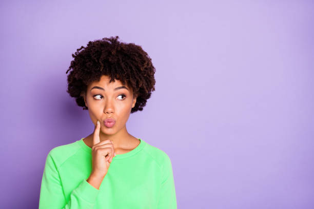 istock Photo of trendy cute nice attractive pondering millennial pouting her lips thinking on her plans about future looking into empty space nearby isolated over purple pastel color background 2201876145