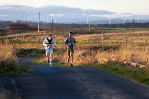 istock Running Along a Quiet Country Lane at Sunset 2201876534