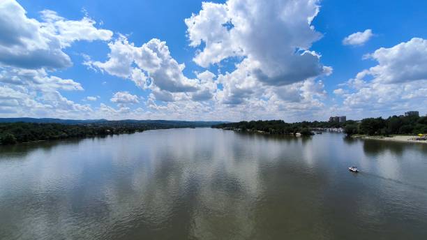 istock blue sky with white clouds reflected in y=the Danube river in Novi Sad 2201877412