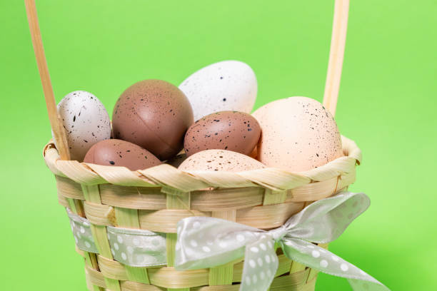Green and yellow color decorative Easter Eggs in transparent egg holder with shiny egg shaped chocolates