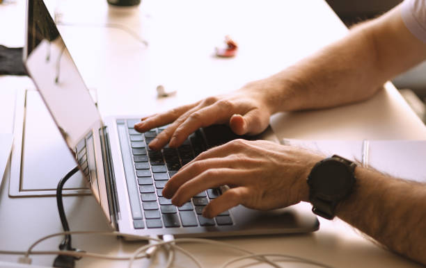 istock Hands of young modern office manager over laptop keyboard 2201881622