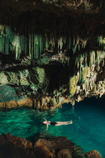 istock Traveller Floating in Scenic Hidden Cave on Crystal Blue Water 2201881636