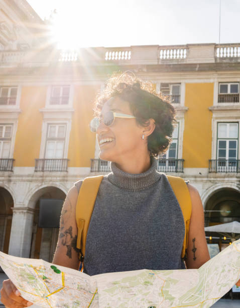 istock Young tourist exploring lisbon with map and backpack in sunlight 2201884526