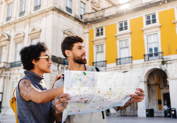 istock Tourists consulting map in lisbon, portugal 2201884539