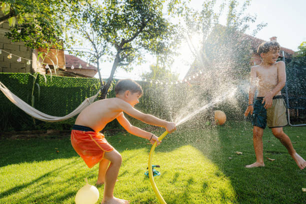 istock Water fight in our yard 2201884682