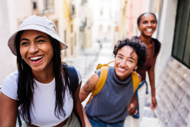 istock Three young women tourists laughing while exploring lisbon 2201884819