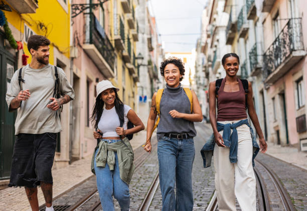 istock Young tourists walking down cobblestone street in lisbon 2201885480