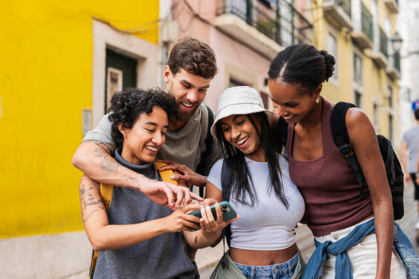 istock Group of tourists using smartphone and having fun in lisbon 2201885487