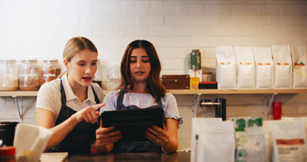istock Cafe, barista and manager with tablet for restaurant management, orders or customer service reviews. Women, waiter and business owner with digital technology for coffee shop, startup or ecommerce 2201886004