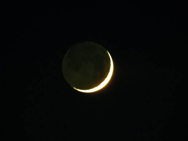 istock moon in waxing crescent phase on dark night sky 2201886259